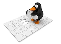 Penguin standing on jig-saw puzzle holding last piece.